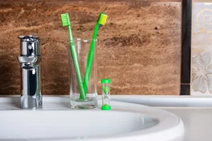 Set of toothbrushes on bathroom basin