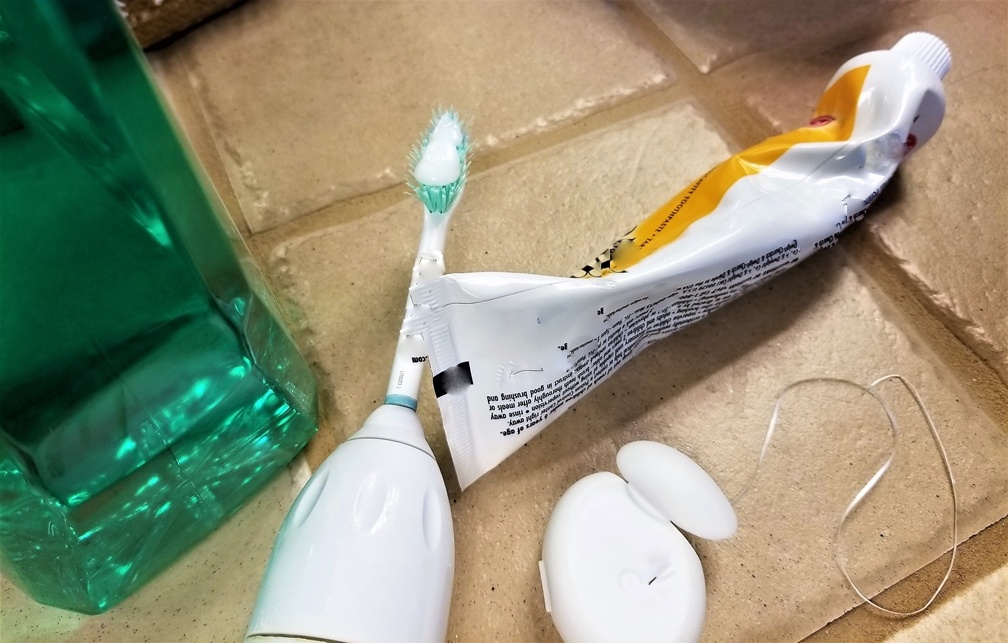 girl with braces brushing her teeth